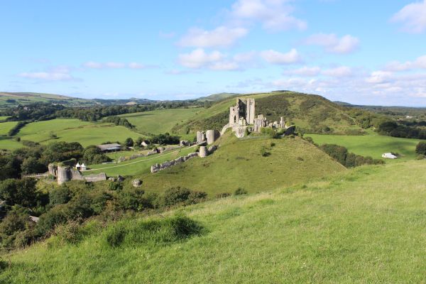 View of Corfe Castle across valley